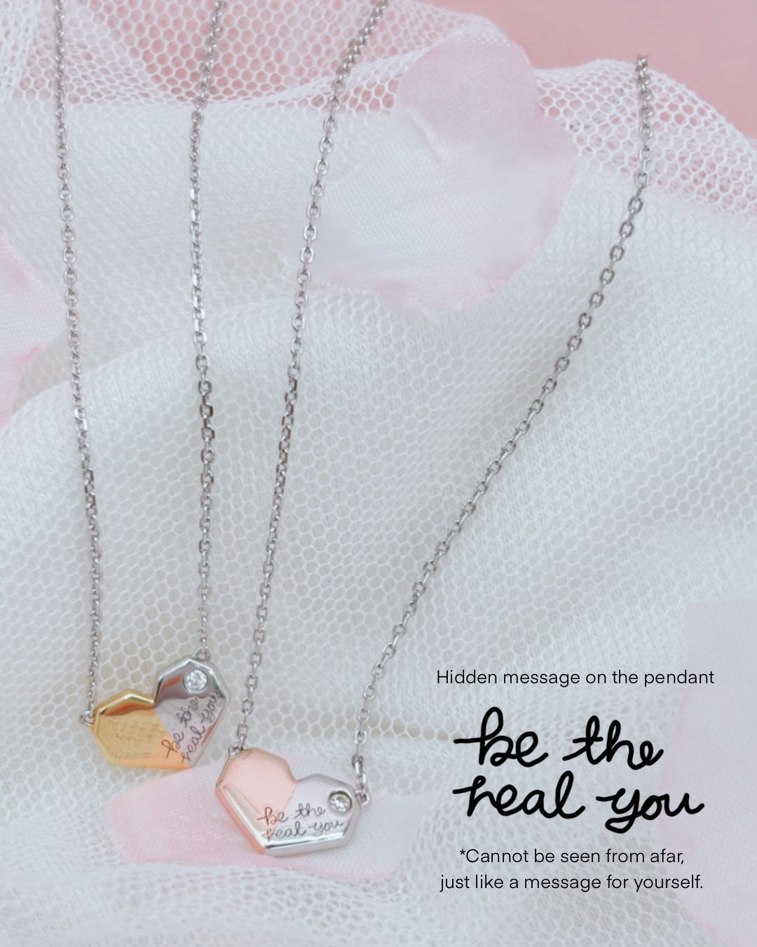 Solid Silver pendant with 2 tone plating in the shape of a heart shape paper message, with a white topaz stone and engraving "be the real you" on the right hand side