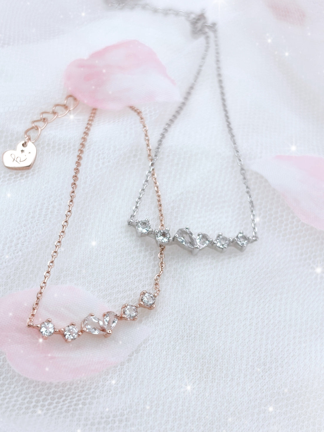 Solid S926 silver pendant made up of 2 different pear shaped white topaz stones, creating an imperfect heart shap, with 2 round white topaz stones at both sides of the imperfect heart